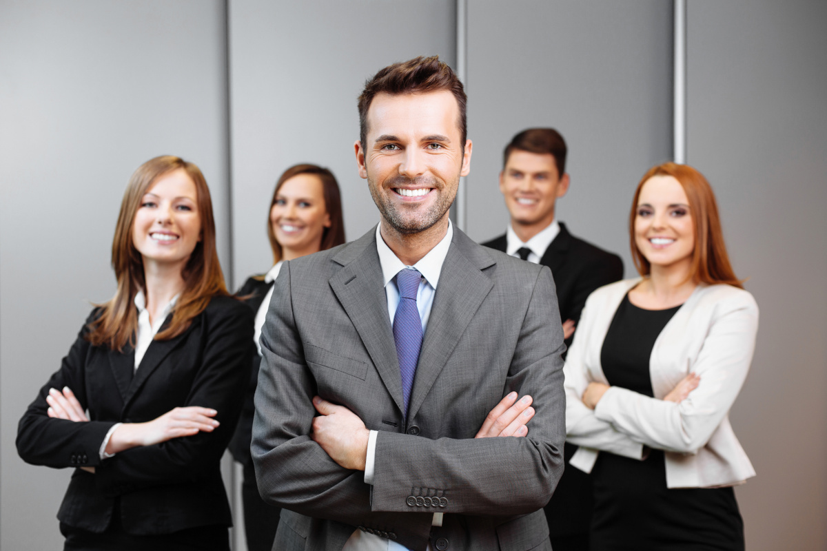 A group of people in business attire standing in a row